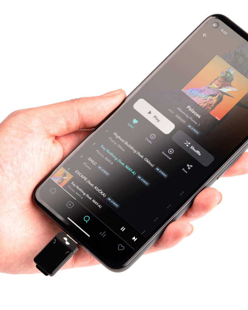 Transmitter plugged into phone playing music from Tidal app